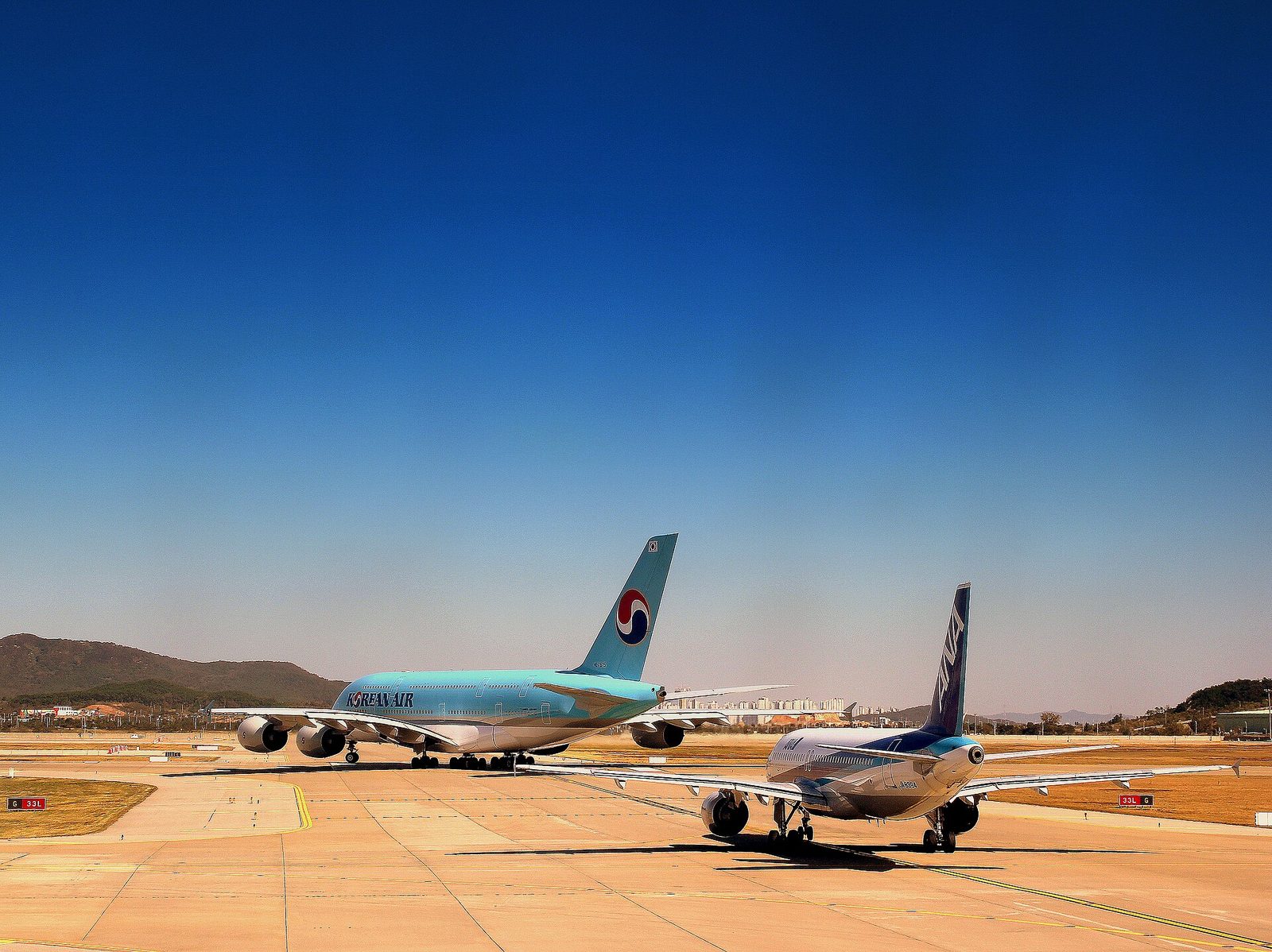Travelers choosing between the AREX train, airport buses and taxis at Incheon Airport
