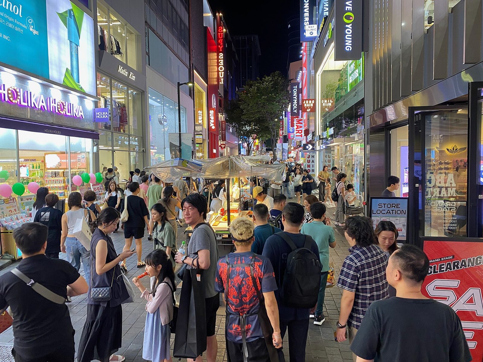 Evening street-food stalls and crowds in Myeongdong, Seoul